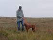 Jim helping Vizsla pup Peak hold point