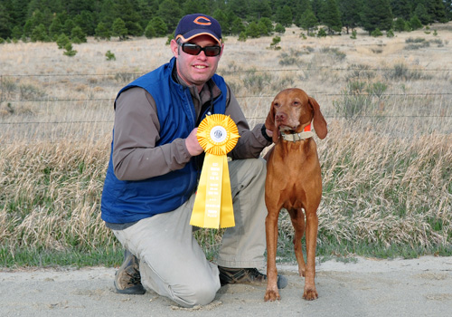 Owner/hanlder/trainer Aaron poses with his Vizsla Kosmo and their 3rd place ribbon from the Amateur Gun Dog 4 point retrieving stake in the Rocky Mountain Vizsla Club's Inaugural Walking Field Trial