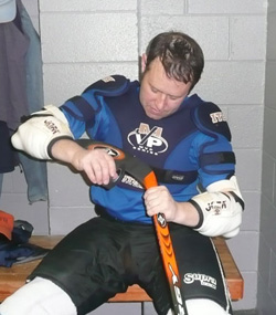 Aaron suiting up to play hockey