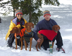 Mel, Aaron snowshoeing in 2006 with their Vizslas Kosmo, Remus, and Lola
